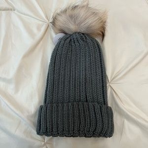 Dark gray pompom hat.